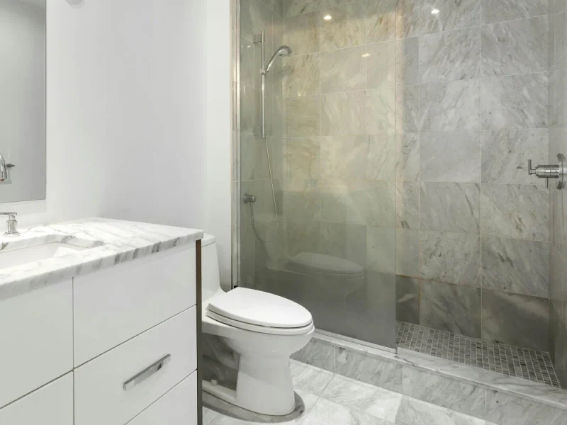 Bright tiled bathroom with a glass shower
