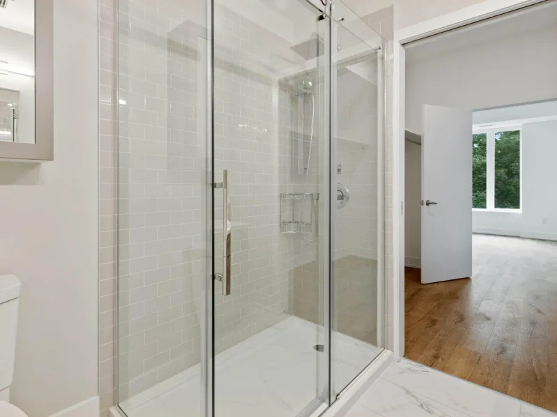 Frameless shower enclosure and tiled floor