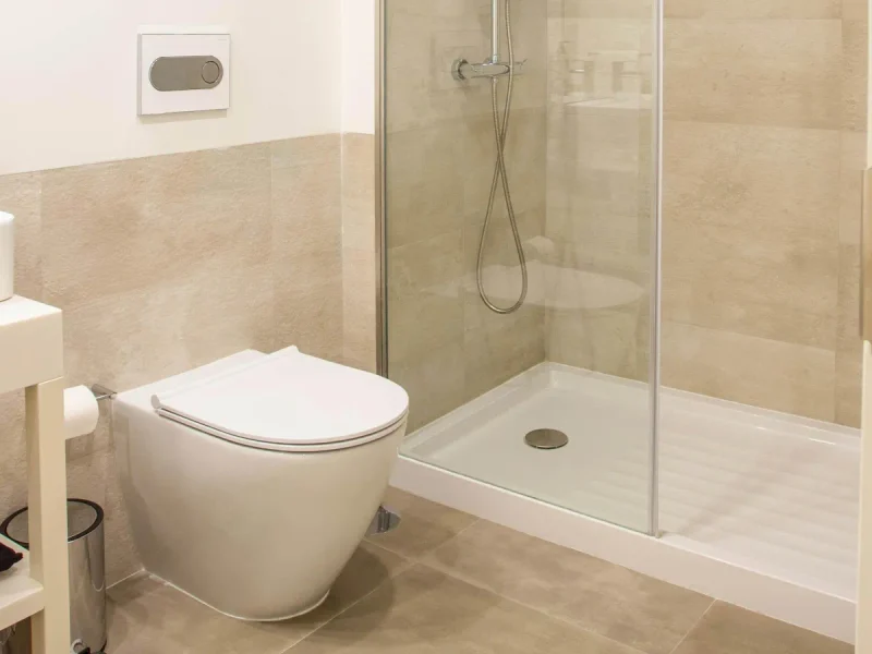 Beige tiled shower and toilet